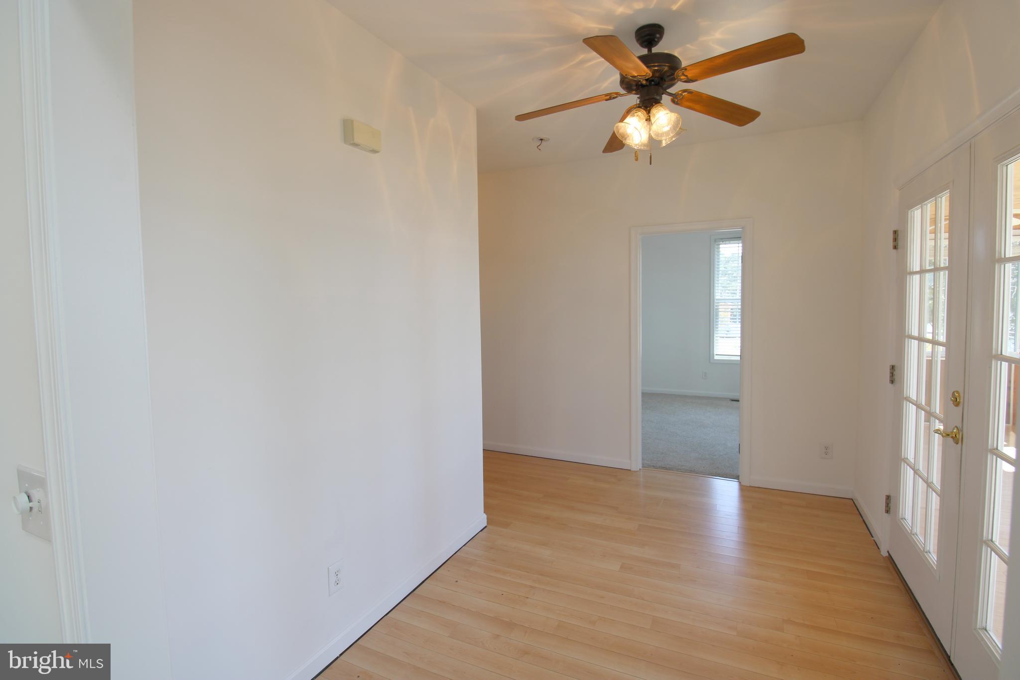40461 Old Breton Beach Road Leonardtown, MD 20650 - Photo 13 of 61 a view of an empty room and window with a chandelier fan