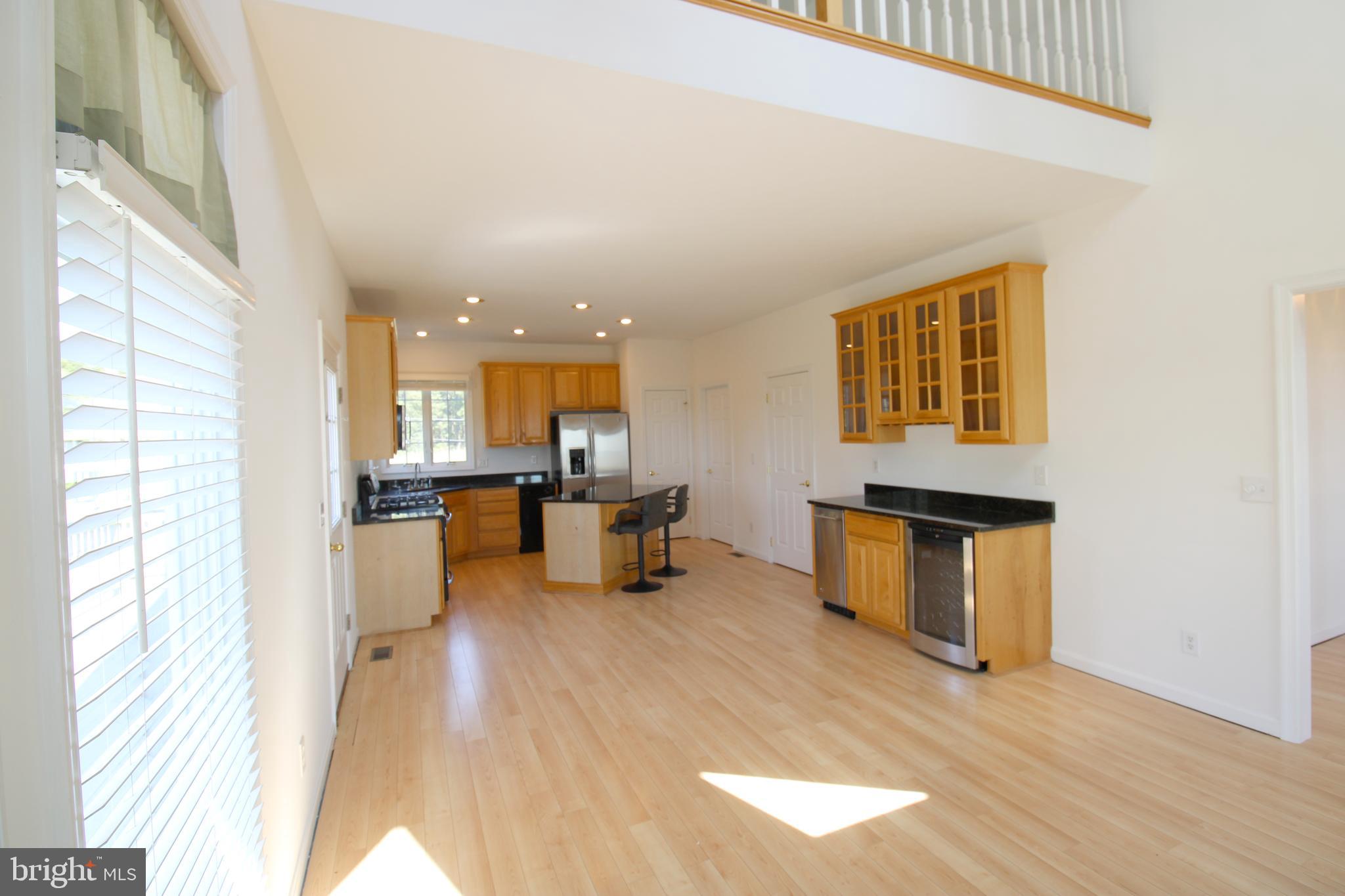 40461 Old Breton Beach Road Leonardtown, MD 20650 - Photo 22 of 61 a view of a living room with furniture and a kitchen