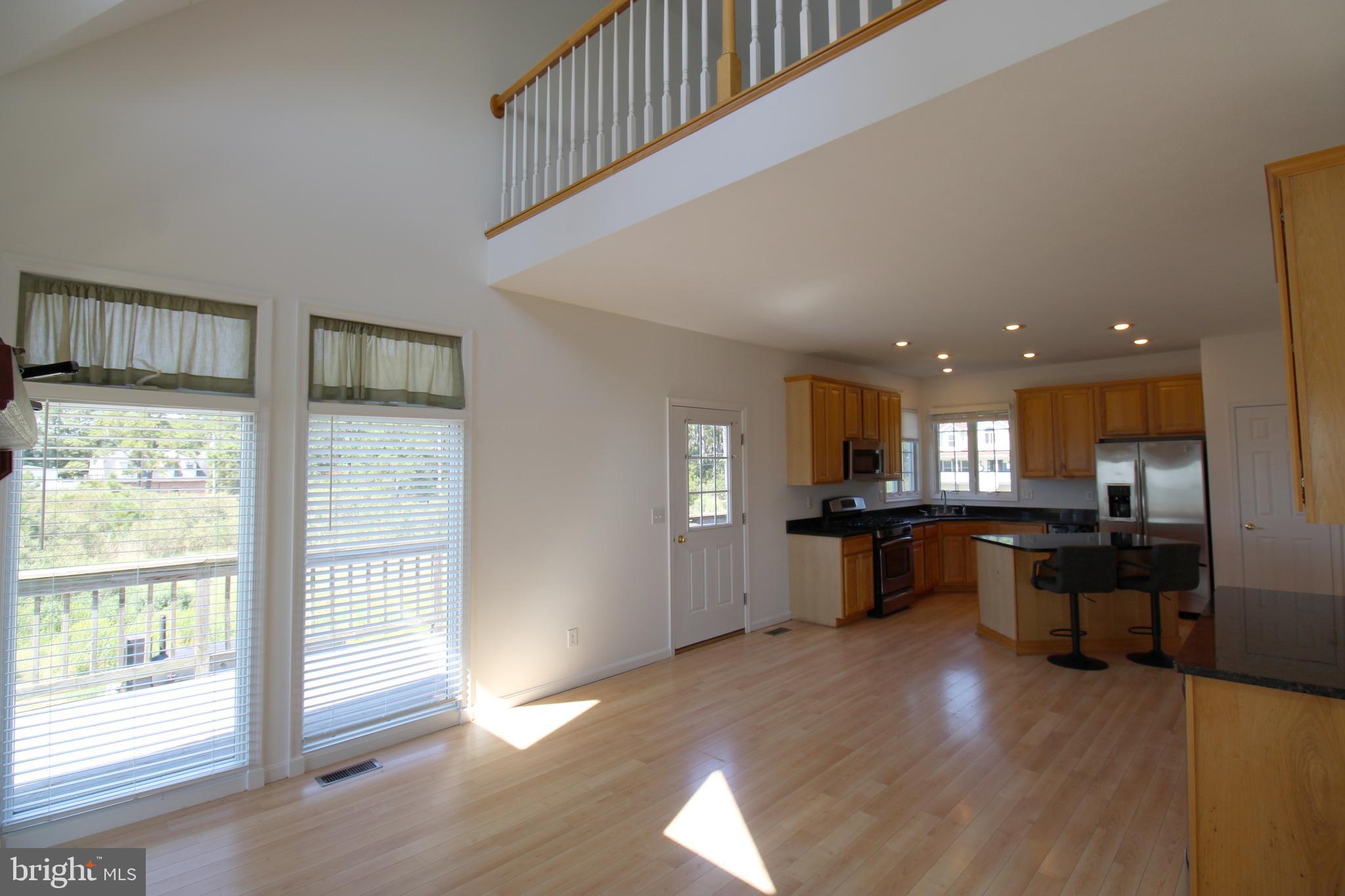 40461 Old Breton Beach Road Leonardtown, MD 20650 - Photo 25 of 61 a large kitchen with a table and chairs in it