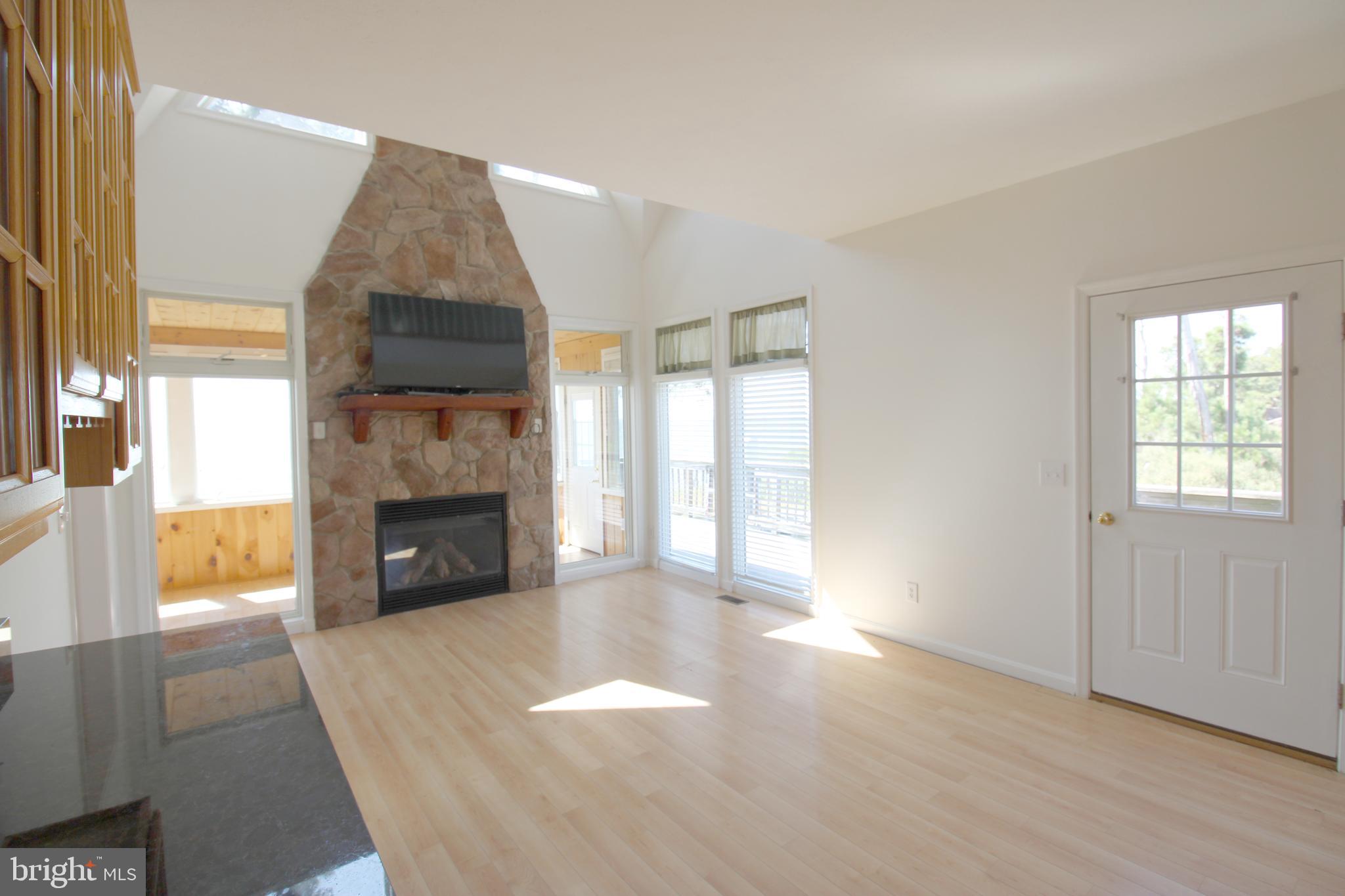 40461 Old Breton Beach Road Leonardtown, MD 20650 - Photo 26 of 61 a view of empty room with a fireplace and windows