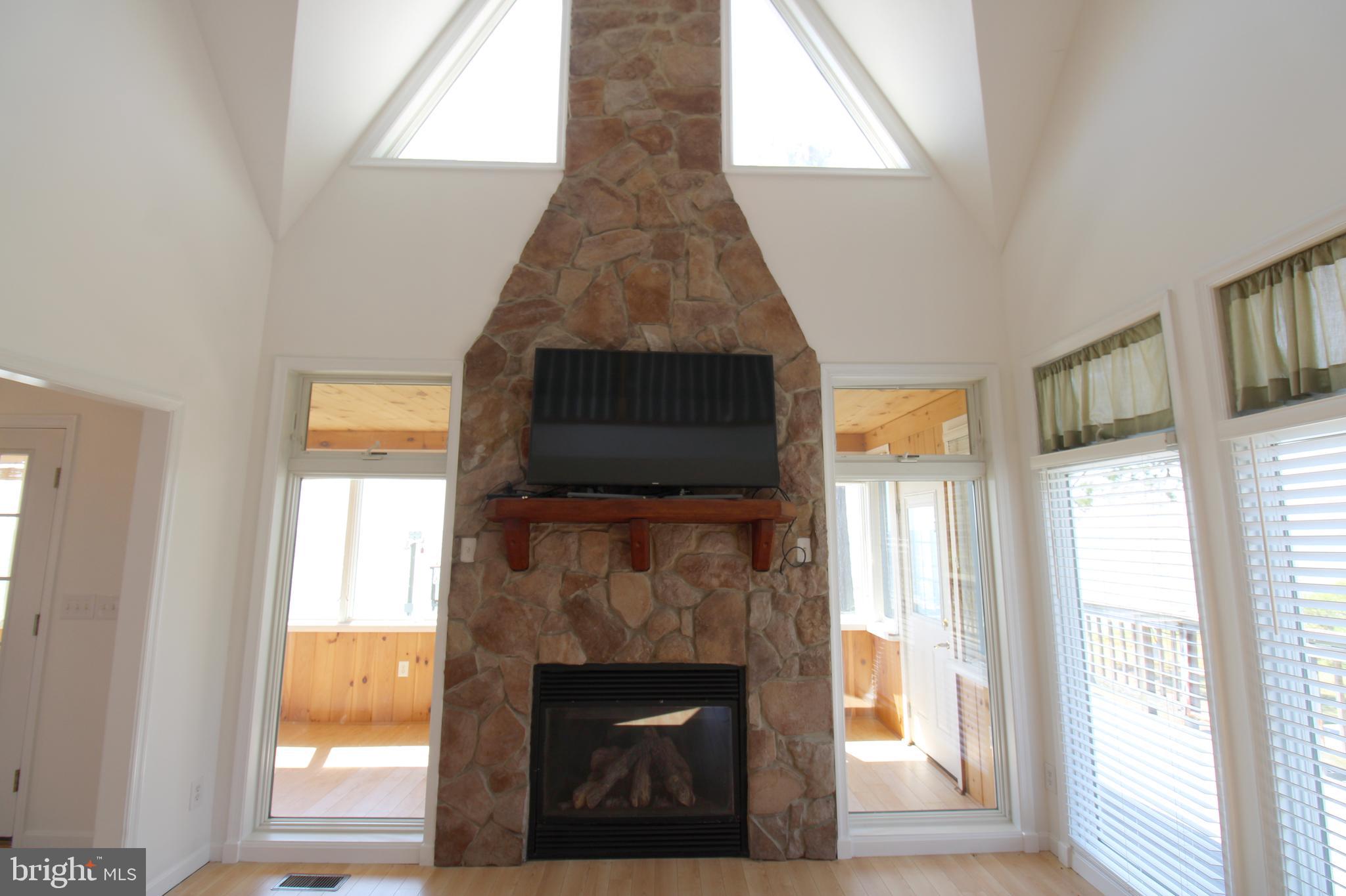 40461 Old Breton Beach Road Leonardtown, MD 20650 - Photo 27 of 61 a living room with a fireplace and a window