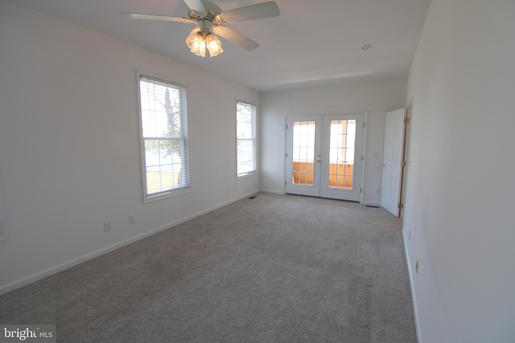 40461 Old Breton Beach Road Leonardtown, MD 20650 - Photo 29 of 61 an empty room with windows and ceiling fan