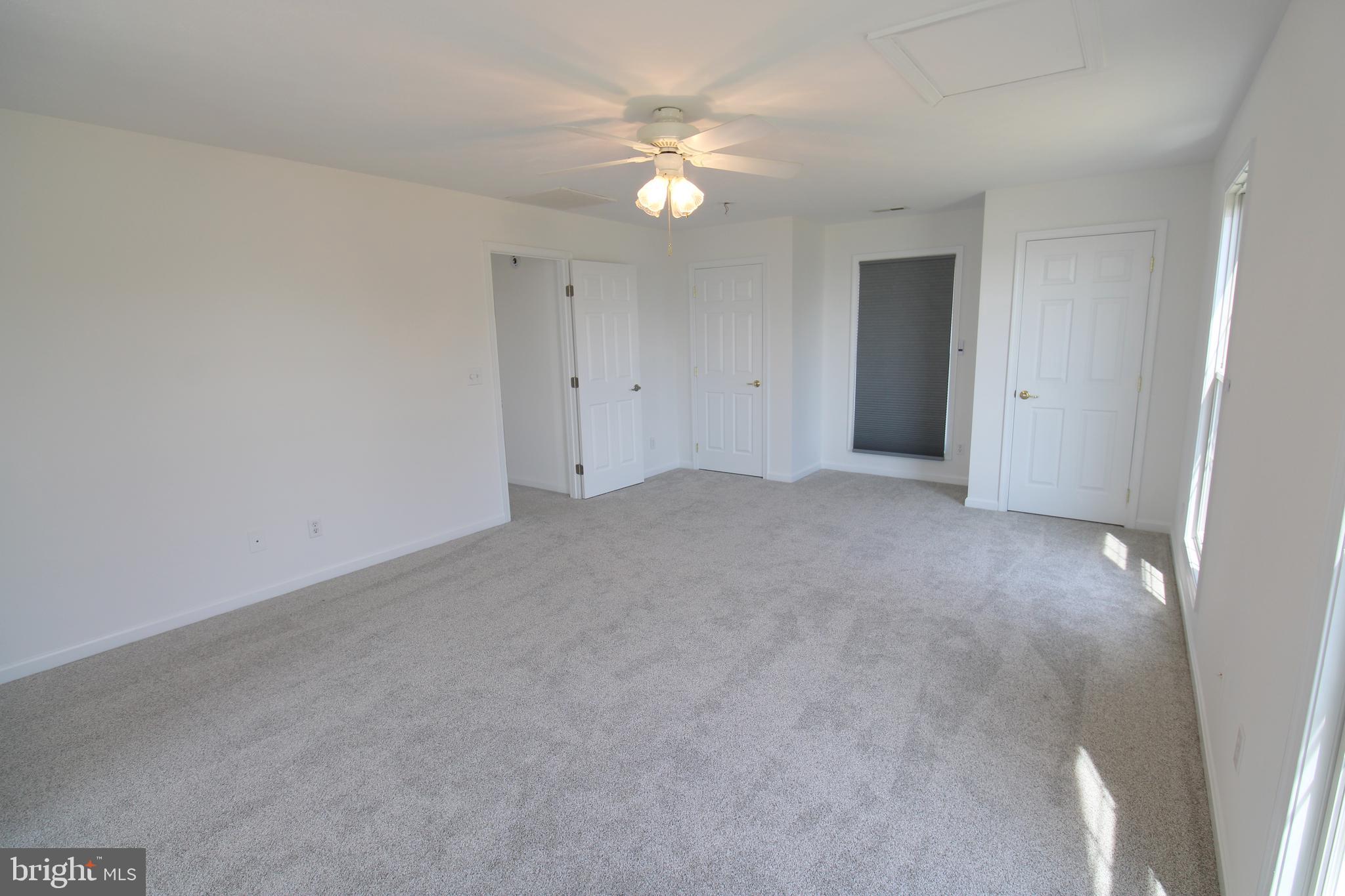 40461 Old Breton Beach Road Leonardtown, MD 20650 - Photo 41 of 61 a view of an empty room with a ceiling fan