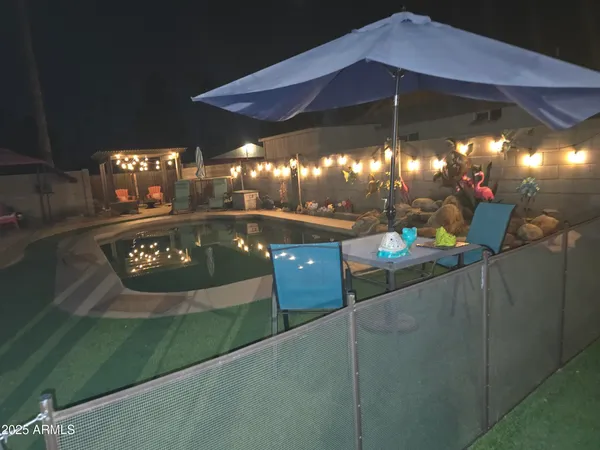 a view of a tables and chairs under an umbrella