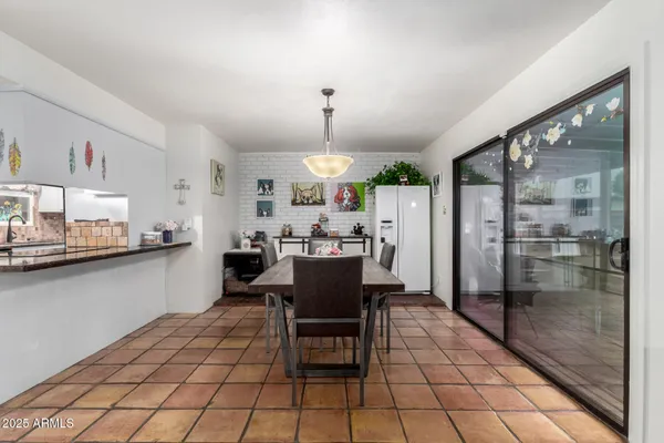 a view of a dining room with furniture and a chandelier