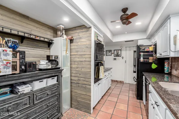 a kitchen with stainless steel appliances granite countertop a refrigerator and a stove