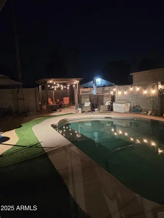 a view of a swimming pool with an outdoor seating