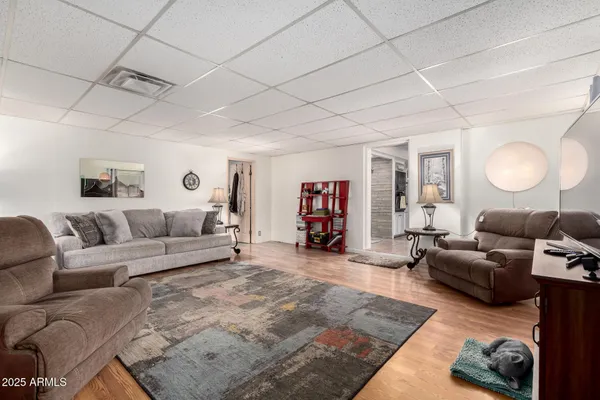 a living room with furniture and a wooden floor