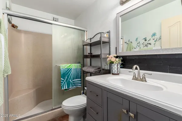 a bathroom with a sink toilet and shower