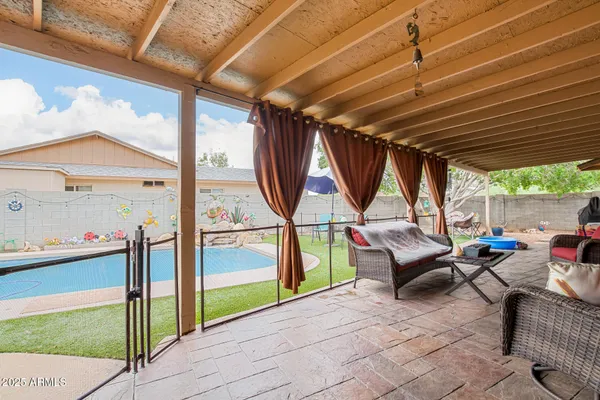 a patio with yard and outdoor seating