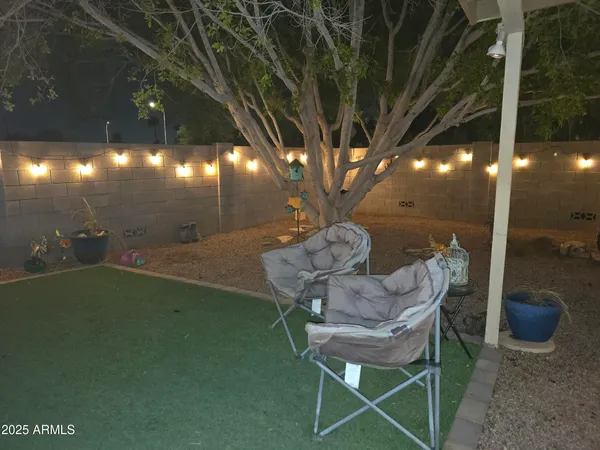 a view of a porch with furniture and a yard