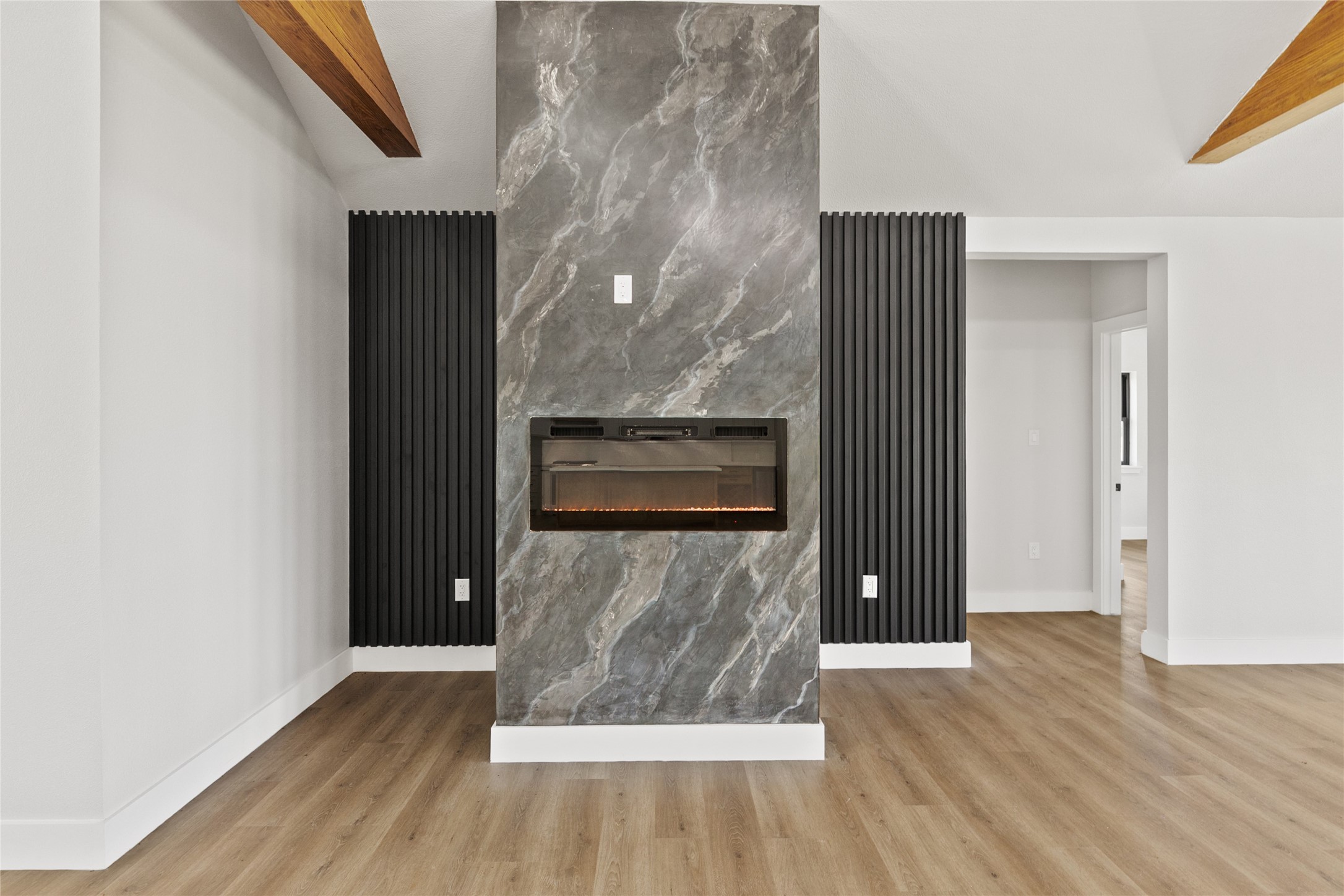 619 Chuckwagon Trail Angleton, TX 77515 - Photo 17 of 37 The dining area showcases a dramatic feature wall with a sleek electric fireplace, creating a stunning focal point that can be enjoyed from nearly every corner of the home's open-concept living spaces.