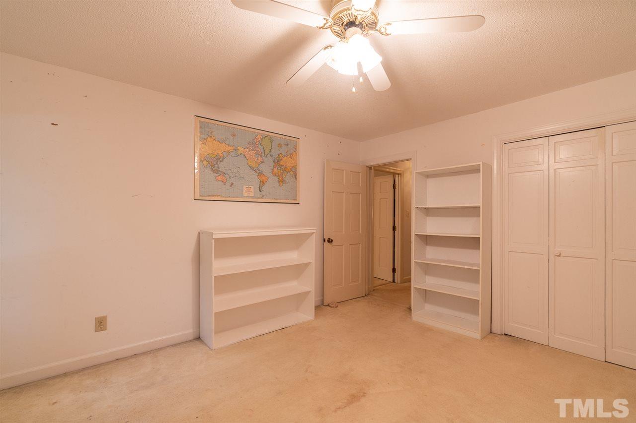 11621 Coachmans Way Raleigh, NC 27614 - Photo 22 of 30 an empty room with closet and a ceiling fan