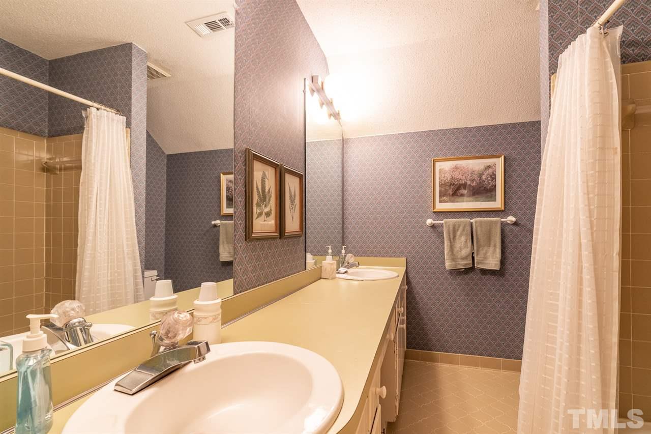 11621 Coachmans Way Raleigh, NC 27614 - Photo 23 of 30 a bathroom with a granite countertop sink and a mirror