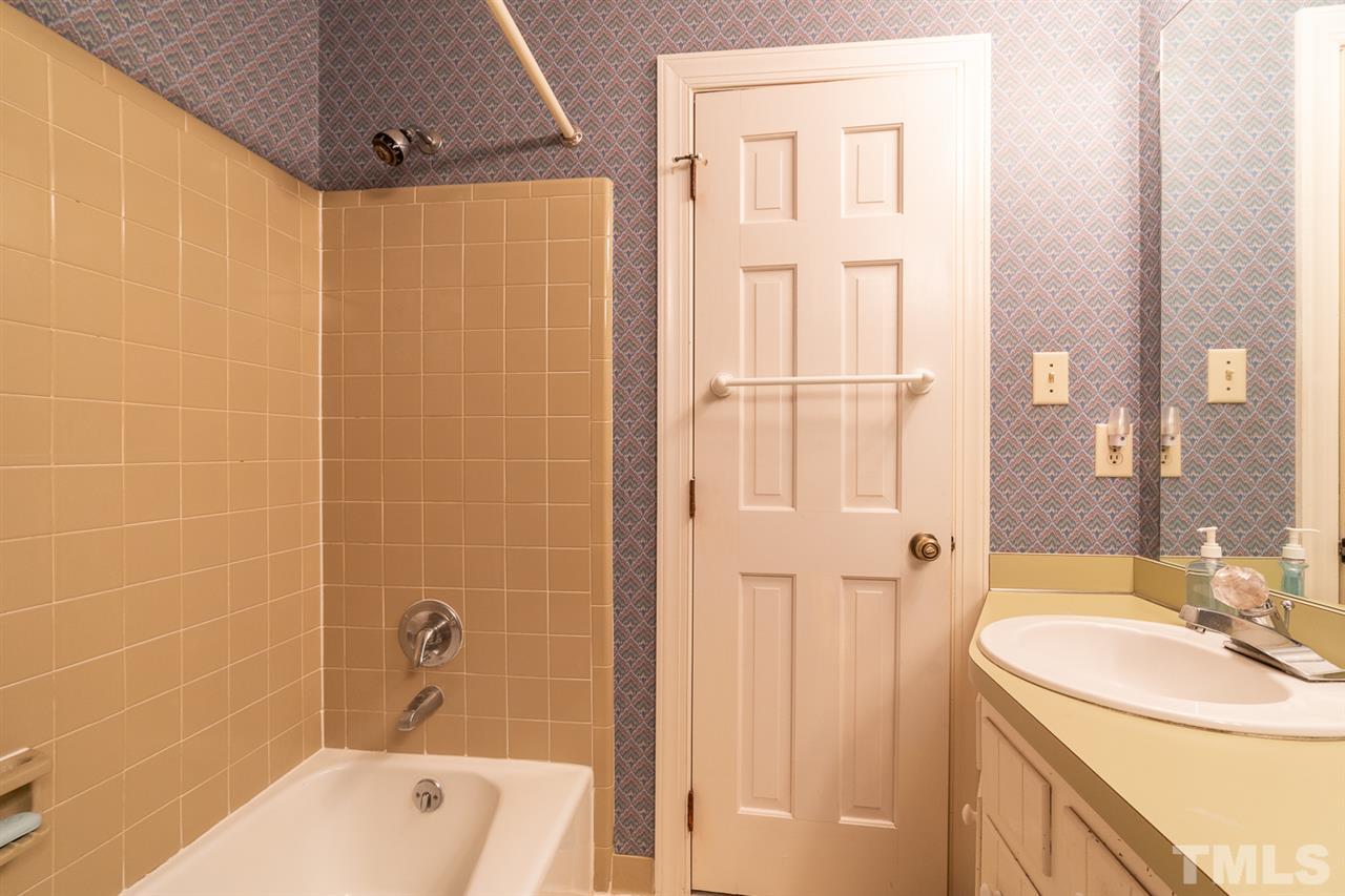 11621 Coachmans Way Raleigh, NC 27614 - Photo 24 of 30 a bathroom with a sink a mirror a bathtub and shower