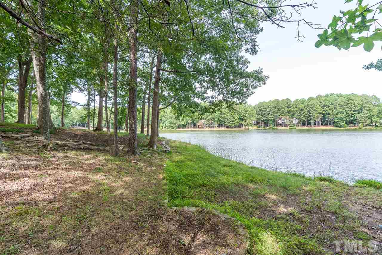 11621 Coachmans Way Raleigh, NC 27614 - Photo 27 of 30 a backyard of a house with lots of green space and lake view