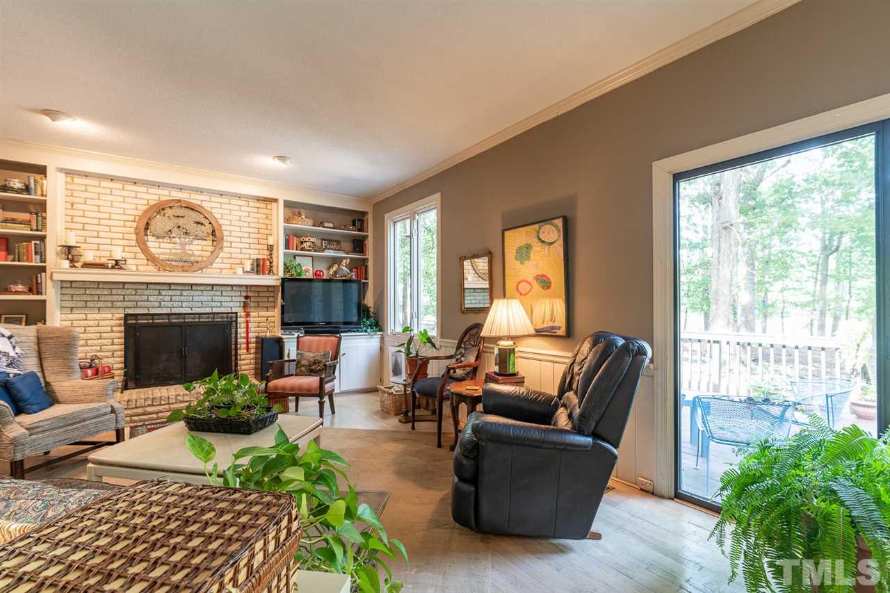 11621 Coachmans Way Raleigh, NC 27614 - Photo 10 of 30 a living room with furniture a large window and a fireplace