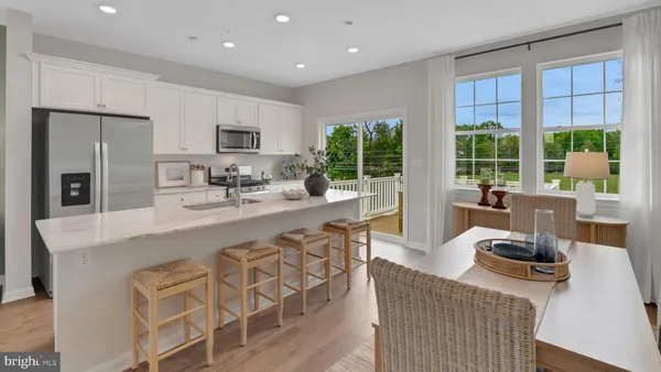 a living room with furniture a large window and a table