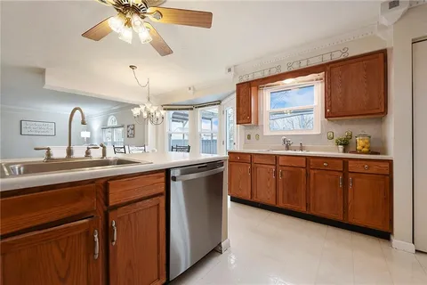 a kitchen with a sink cabinets and window