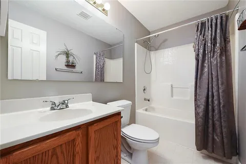 a bathroom with a toilet sink vanity and mirror