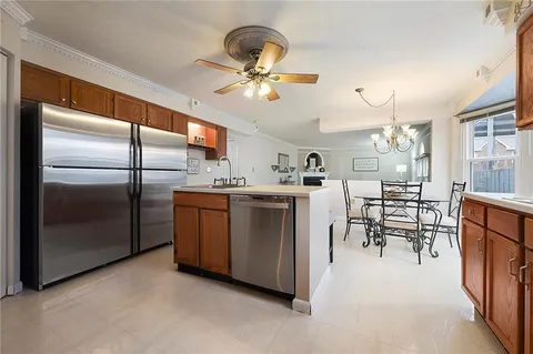 a kitchen with stainless steel appliances granite countertop a stove a sink and a refrigerator with cabinets