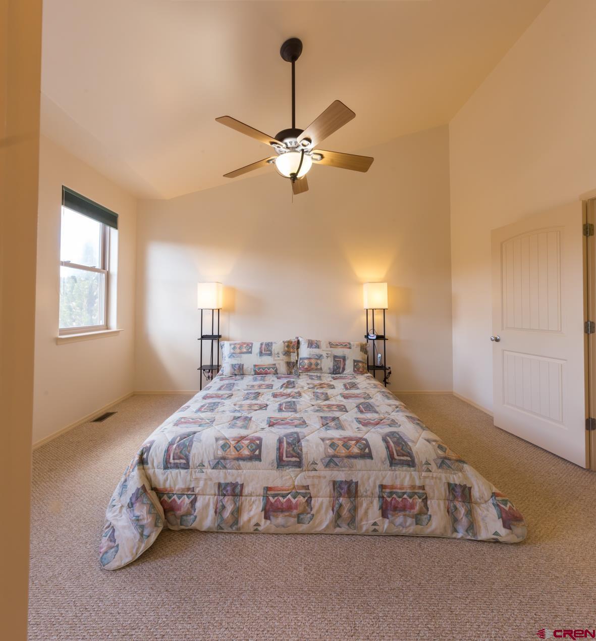 334 Jenkins Ranch Road Durango, CO 81301 - Photo 16 of 35 a bedroom with a bed and a chandelier