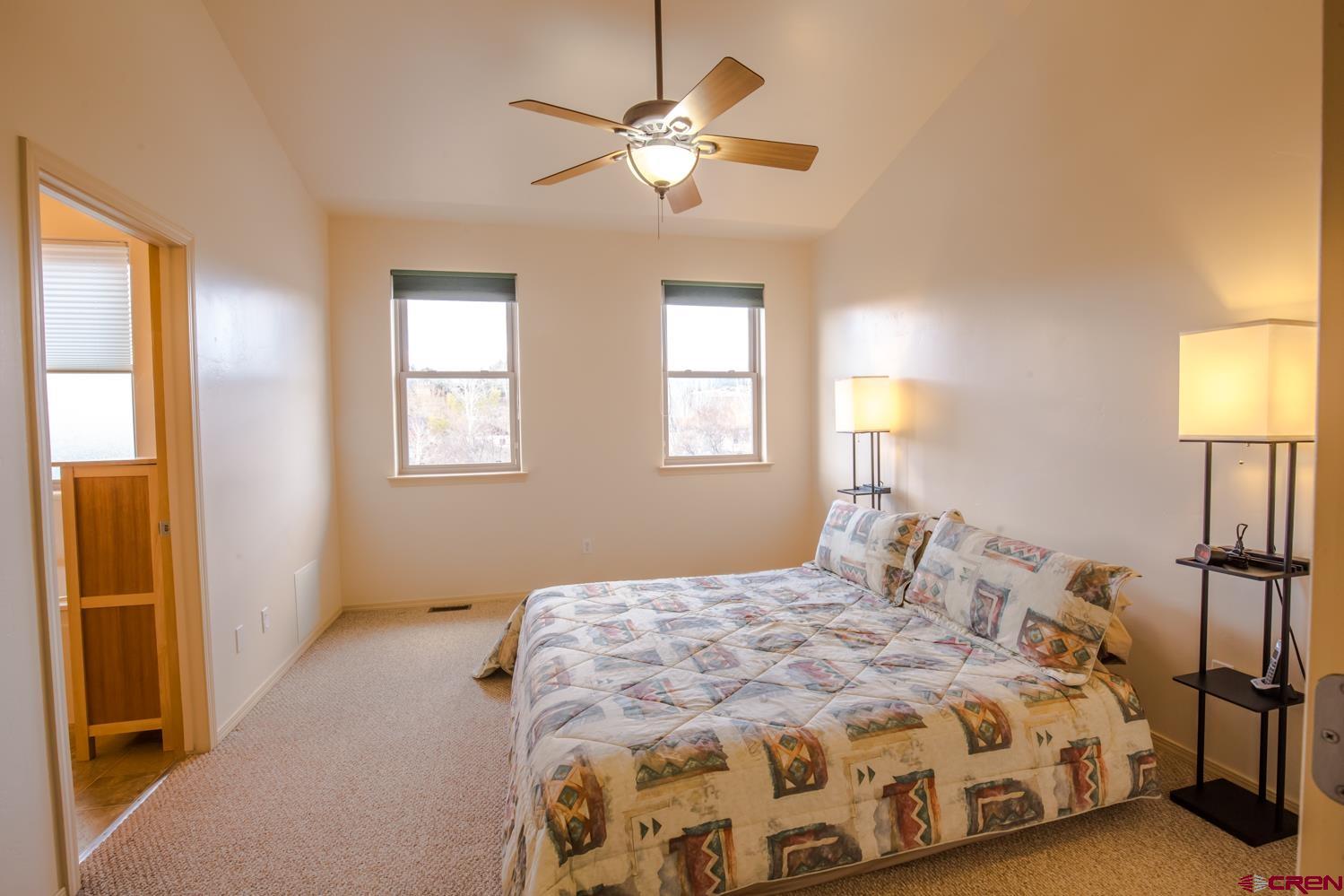 334 Jenkins Ranch Road Durango, CO 81301 - Photo 17 of 35 a bedroom with a bed and a chandelier