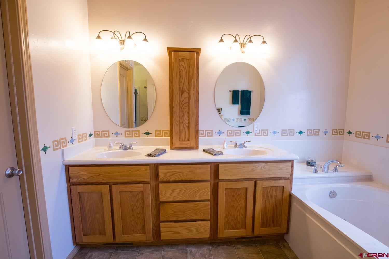 334 Jenkins Ranch Road Durango, CO 81301 - Photo 18 of 35 a bathroom with a double vanity sink and a mirror