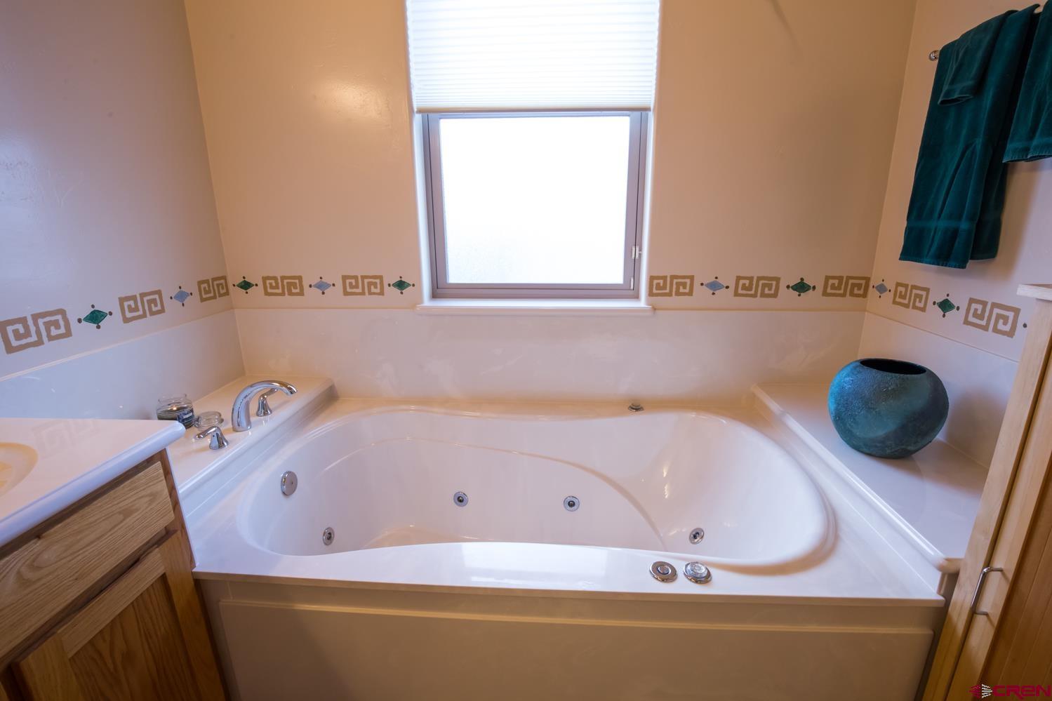 334 Jenkins Ranch Road Durango, CO 81301 - Photo 19 of 35 a bathroom with a tub sink and a mirror