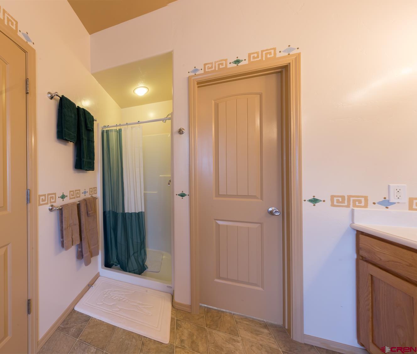 334 Jenkins Ranch Road Durango, CO 81301 - Photo 20 of 35 a en suite bathroom with a sink a mirror and a shower