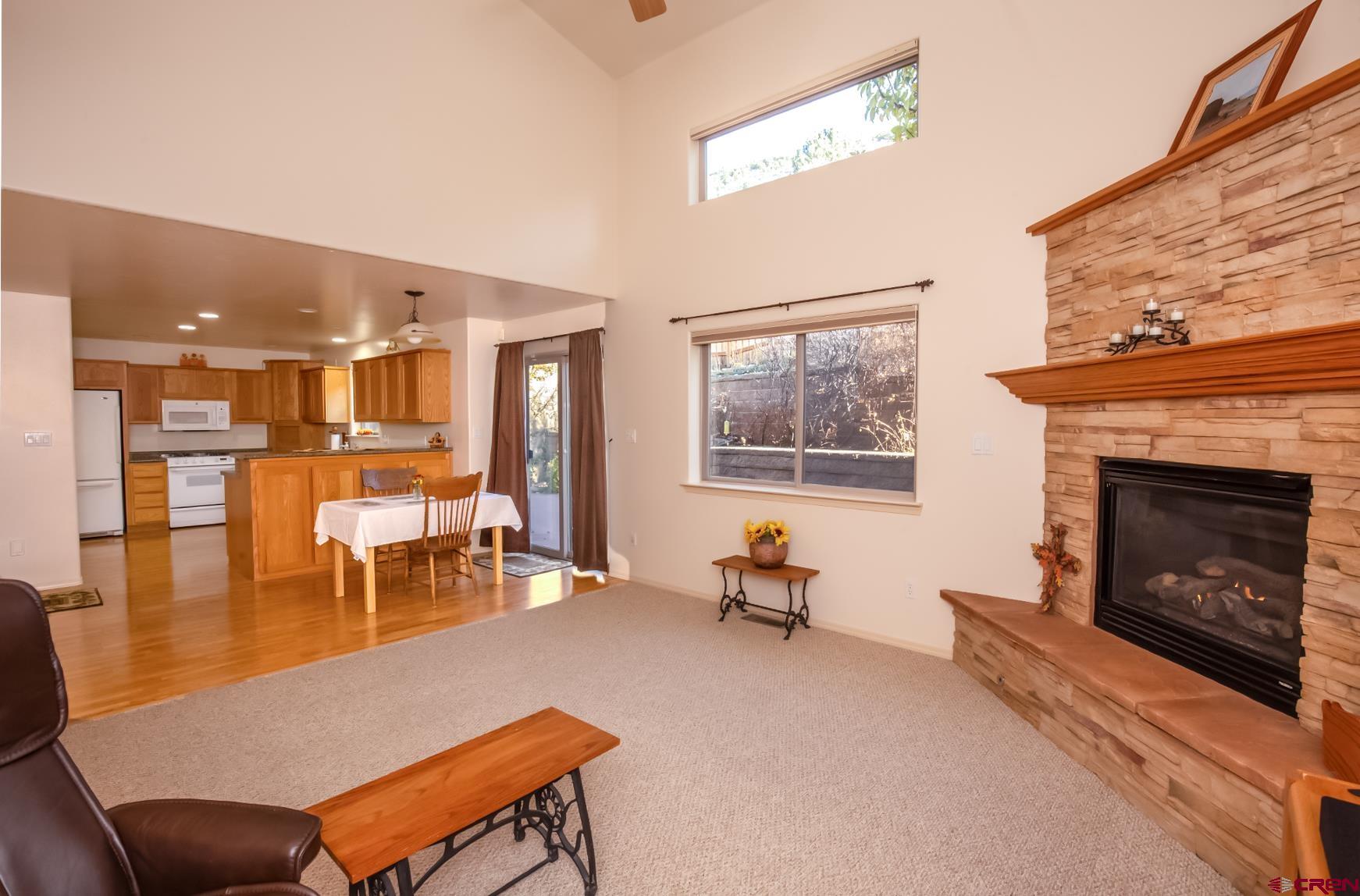 334 Jenkins Ranch Road Durango, CO 81301 - Photo 9 of 35 a living room with furniture a dining table and a fireplace