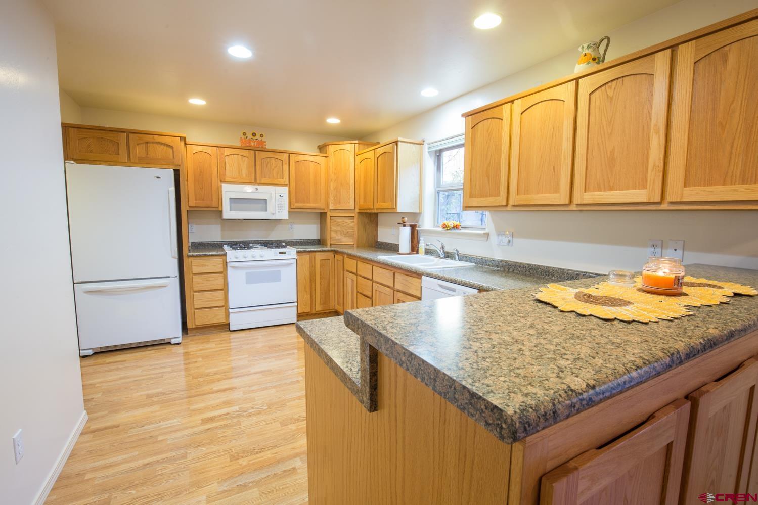 334 Jenkins Ranch Road Durango, CO 81301 - Photo 10 of 35 a kitchen with stainless steel appliances granite countertop a sink stove and refrigerator