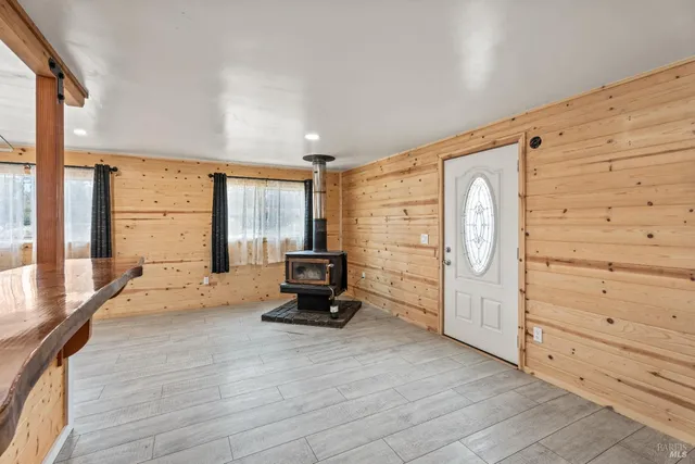 a kitchen with stainless steel appliances kitchen island granite countertop a refrigerator and a stove top oven