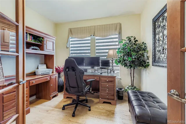 a view of a workspace with furniture and a window