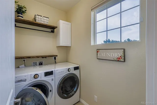 a view of storage and utility room with washer and dryer