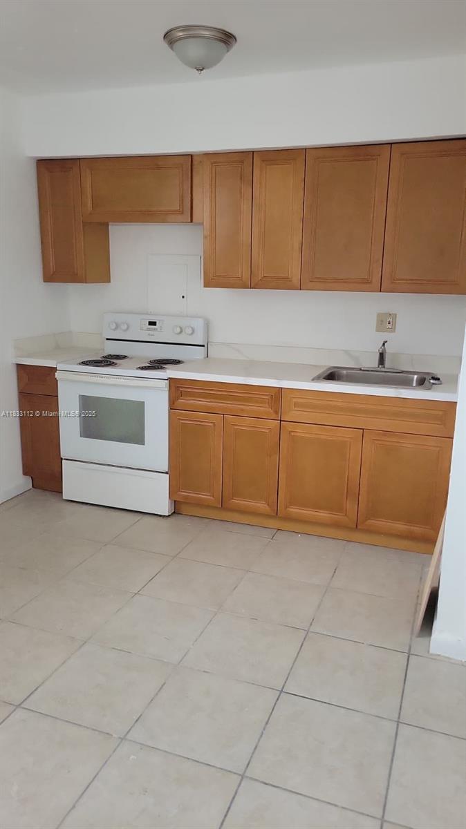 1406 Northwest 2nd Avenue, Unit 2 Florida City, FL 33034 - Photo 3 of 10 a kitchen with granite countertop a sink and cabinets