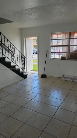 a view of a livingroom with wooden floor and a window