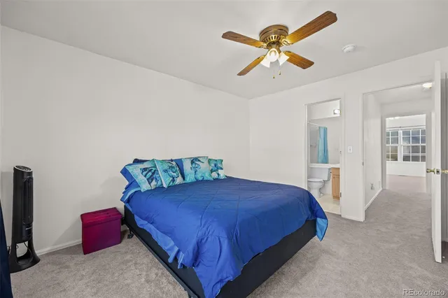 a bedroom with a bed and ceiling fan