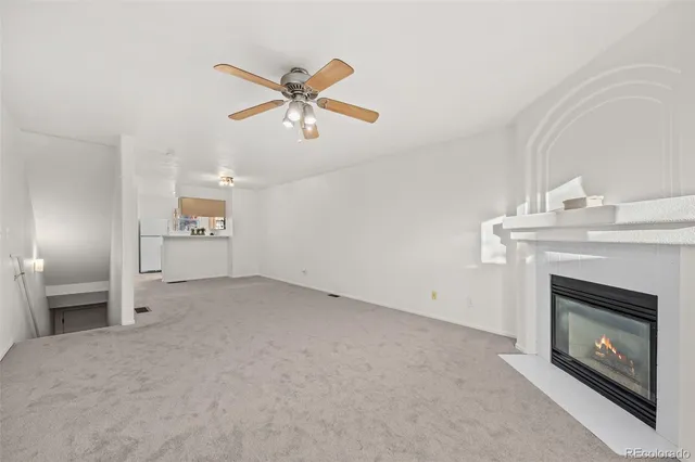 a view of an empty room with a fireplace