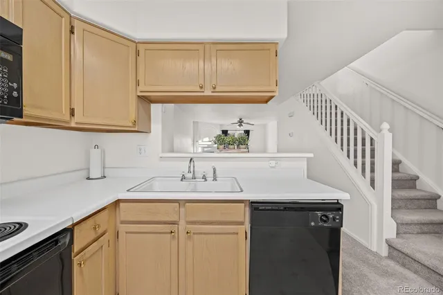 a kitchen with a sink cabinets and a window