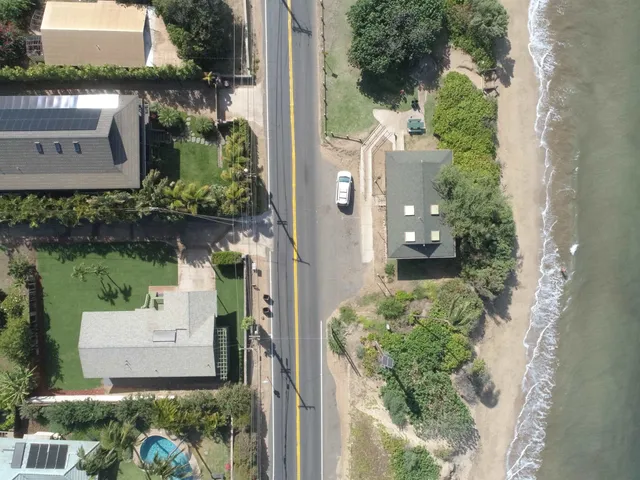 an aerial view of multiple houses with yard