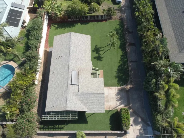 an aerial view of a house with a yard and garden