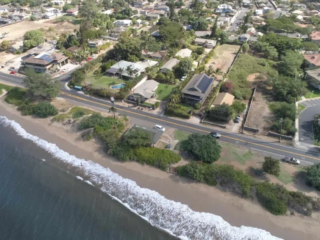an aerial view of a house with a yard and garden