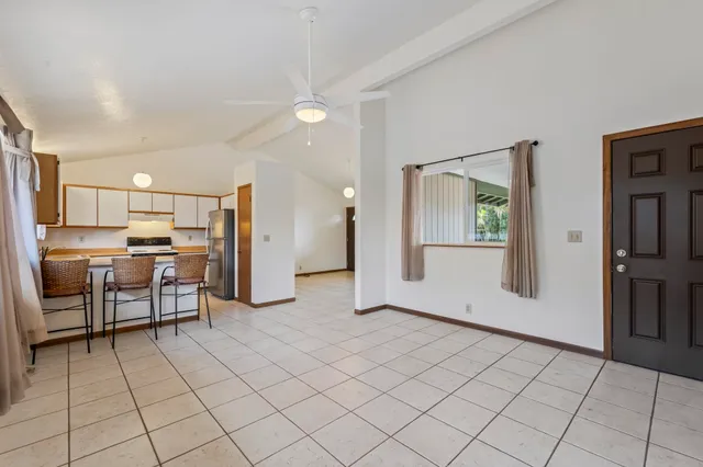 a view of a kitchen with furniture and a refrigerator
