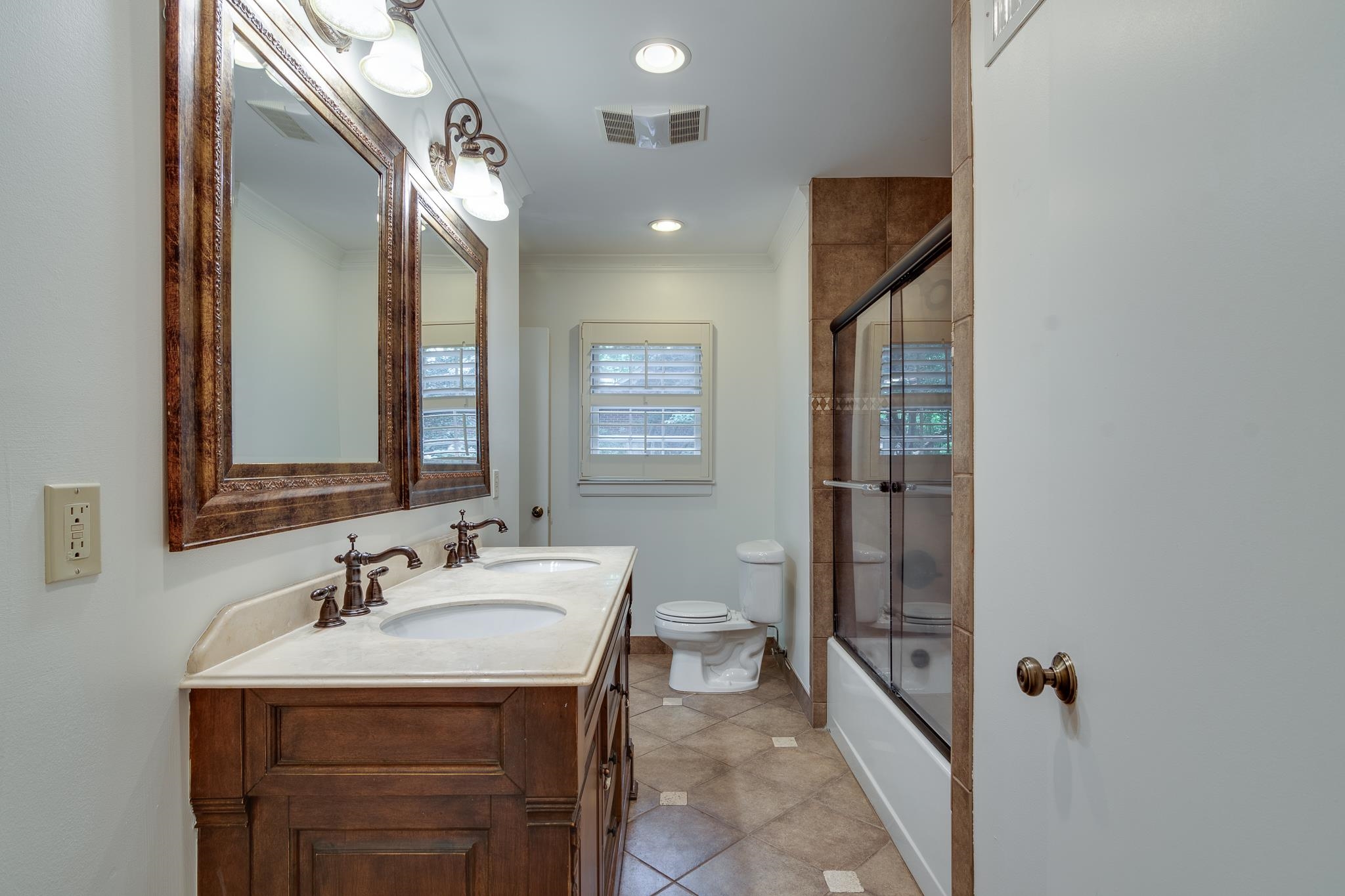 359 Roseland Place Memphis, TN 38111 - Photo 25 of 38 Full bathroom featuring tile floors, shower / bath combination with glass door, toilet, and vanity