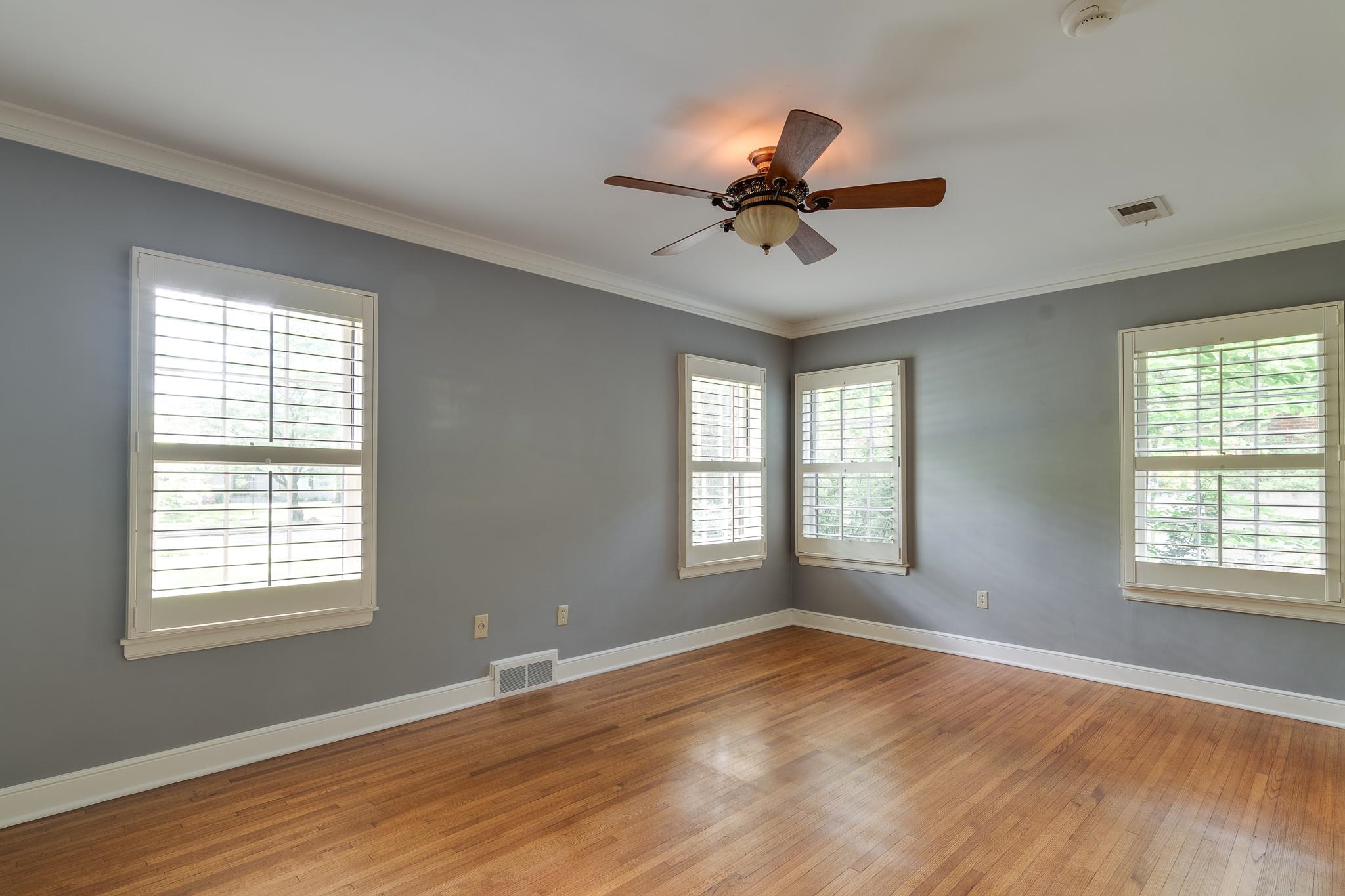 359 Roseland Place Memphis, TN 38111 - Photo 27 of 38 Spare room with crown molding, wood-type flooring, and ceiling fan