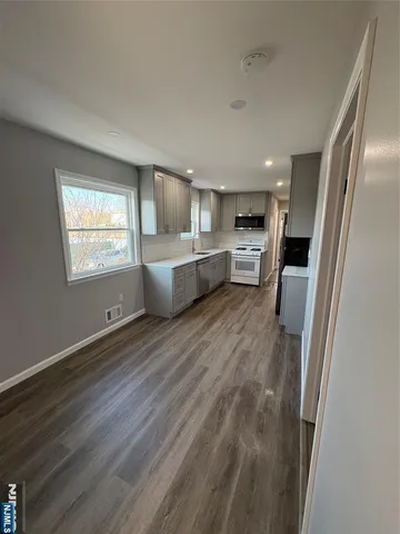 a large space with a lot of cabinets and wooden floor