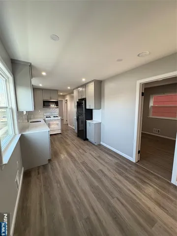 a view of kitchen with furniture and wooden floor