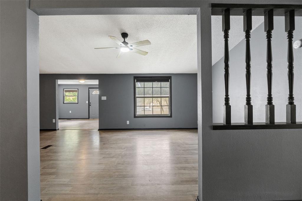 7610 County Road 663 Bushnell, FL 33513 - Photo 17 of 43 a view of a hallway with wooden floor and staircase