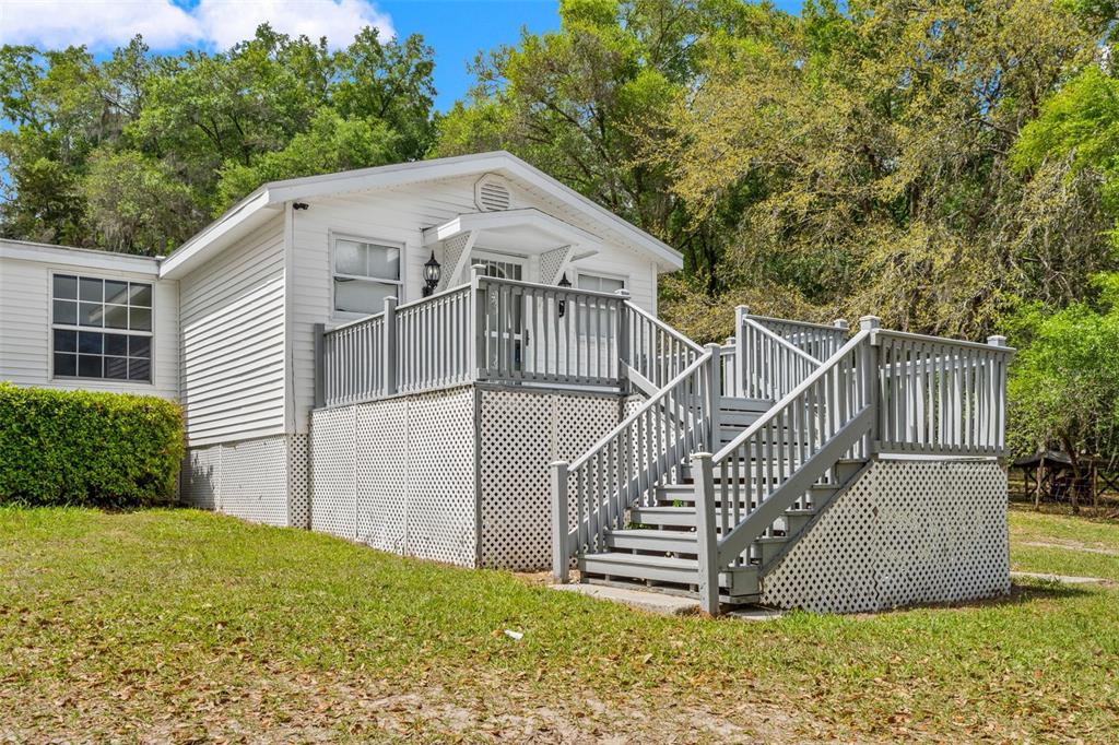 7610 County Road 663 Bushnell, FL 33513 - Photo 2 of 43 a view of a house with a yard and plants